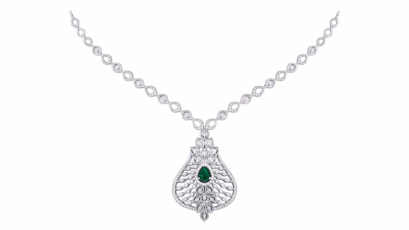 A white gold and diamond necklace featuring a teardrop-shaped pendant with a central green emerald and clear pavé stones, displayed on a solid white background.