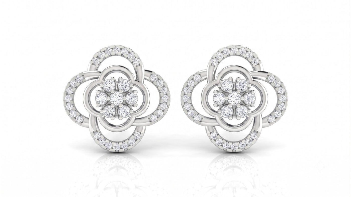 A pair of two-tone white gold and diamond stud earrings with a floral design on a white background.