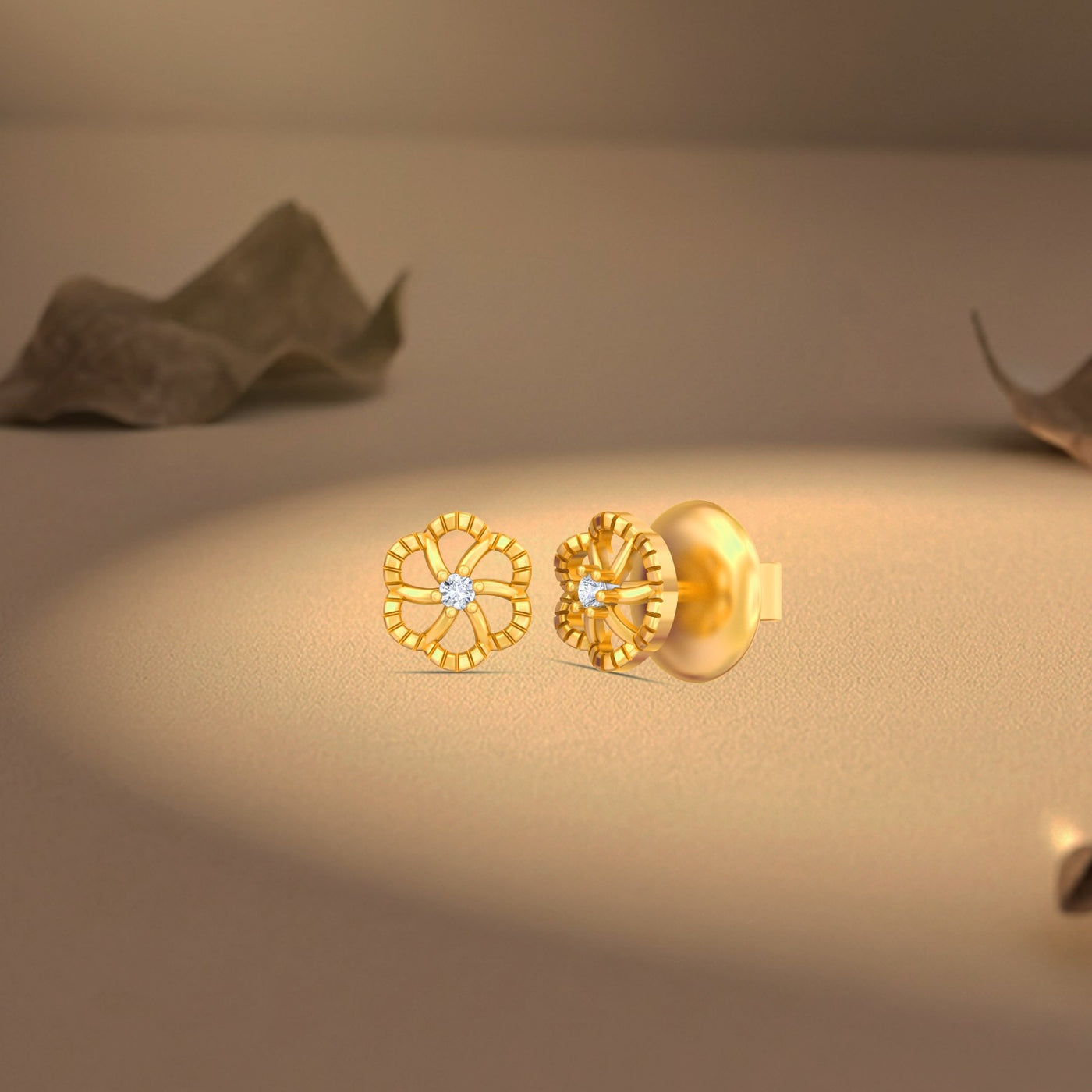 Gold and diamond stud earring on a beige surface