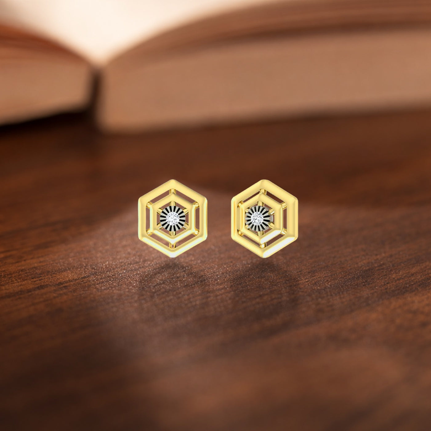 Gold and diamond Hexagon stud earring on a wooden surface.