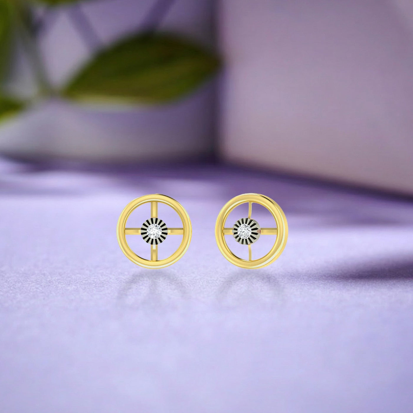 Gold and diamond round-shaped stud earring on a reflective surface.