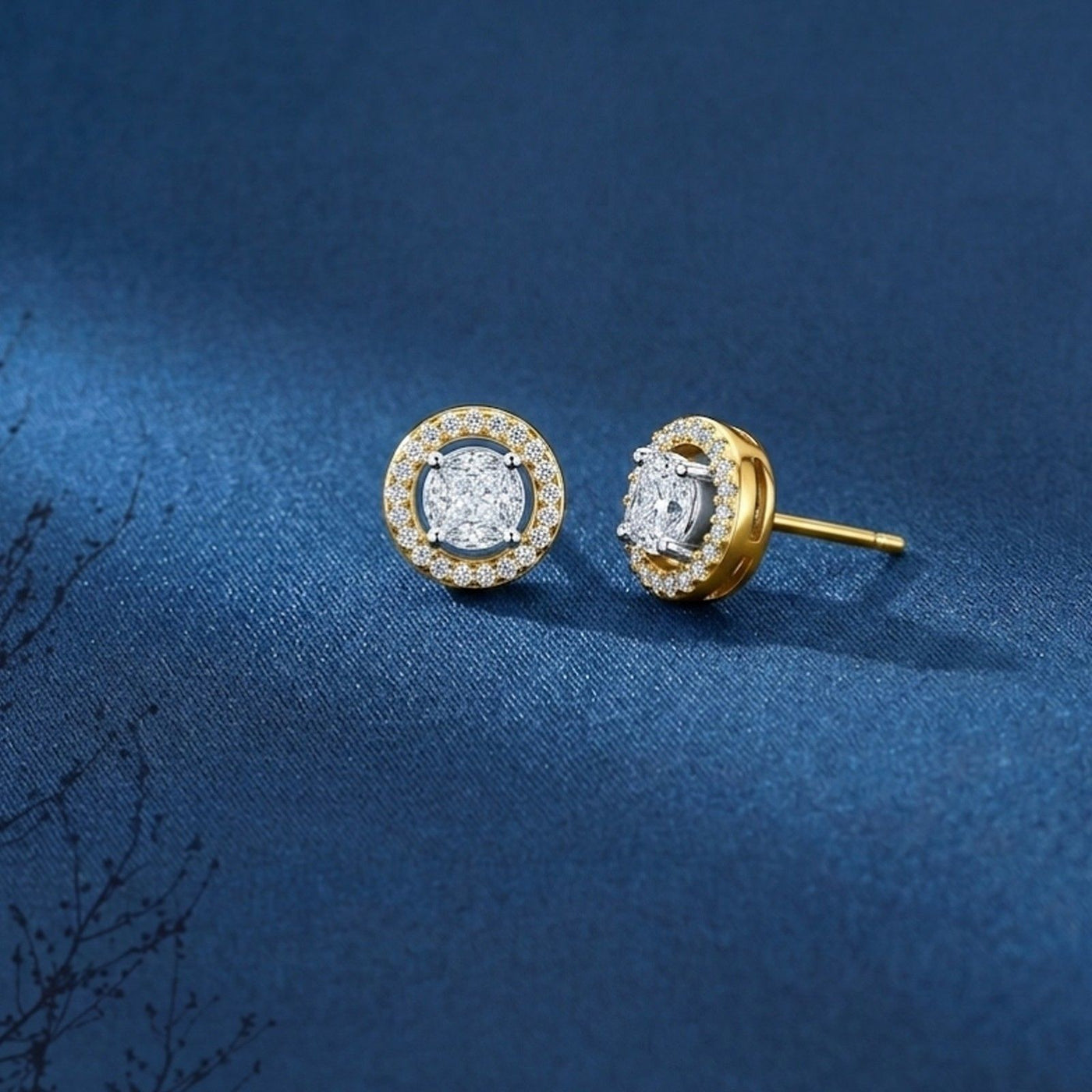 Gold and diamond stud earrings, displaying the front and side views of the circular halo design on a blue fabric background.