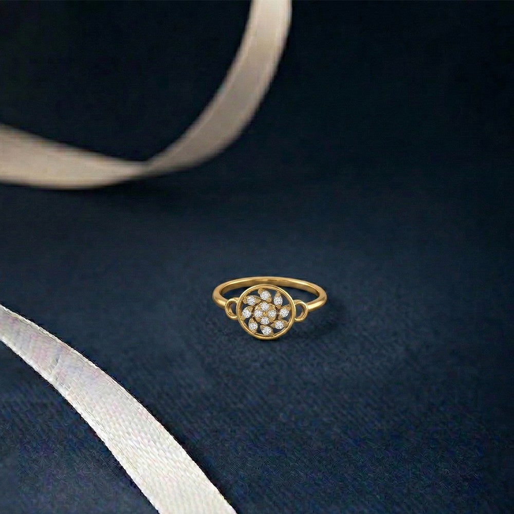Gold ring with embedded stones on a dark blue fabric background