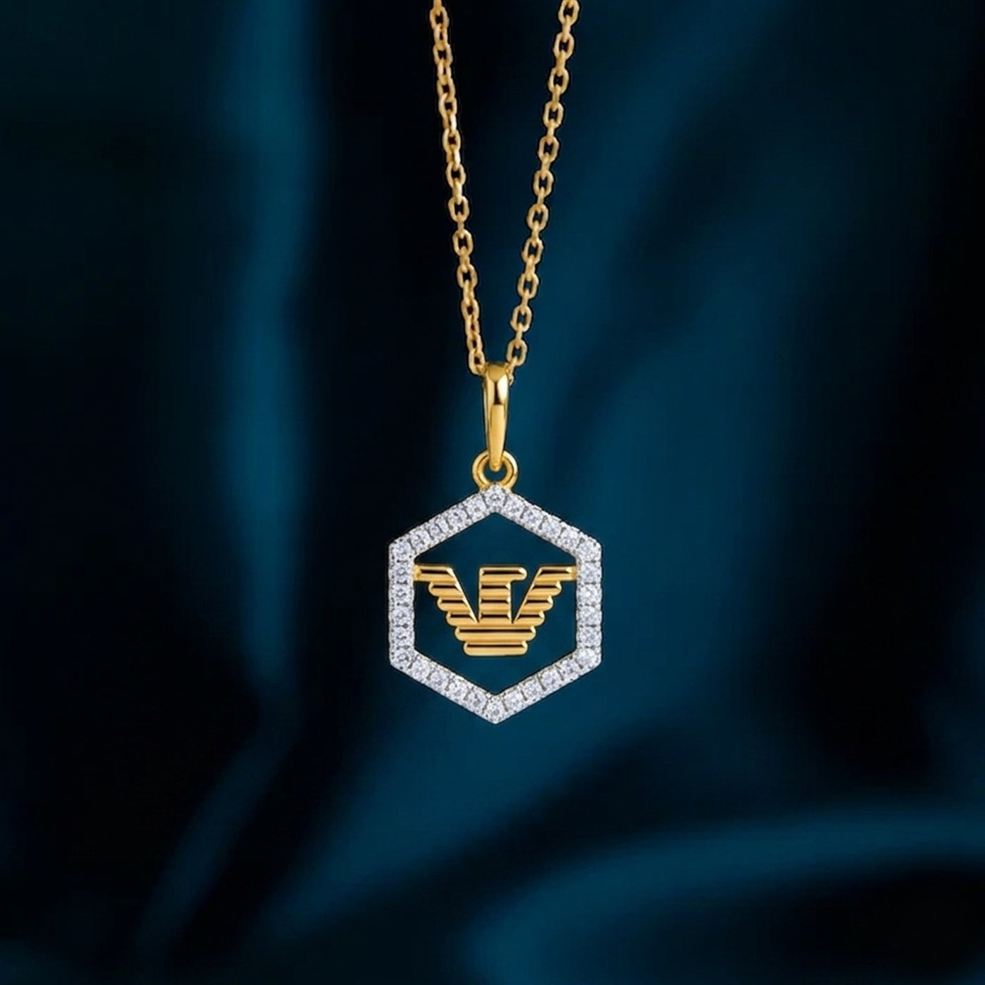 Gold necklace with a hexagonal pendant featuring an eagle emblem on a dark blue background