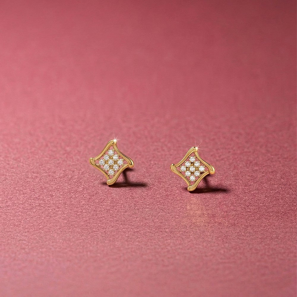 Gold and diamond square stud earrings on a pink background.