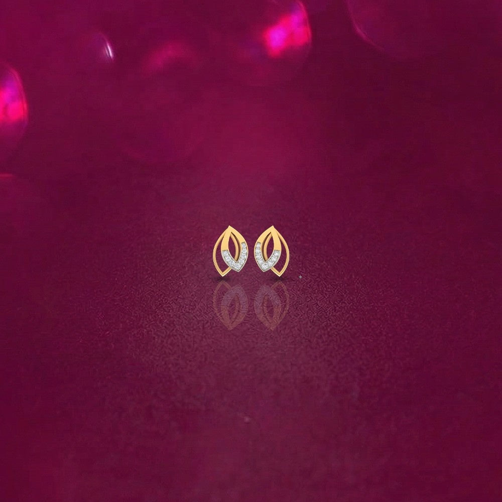 Gold and diamond stud earrings on a pink background.