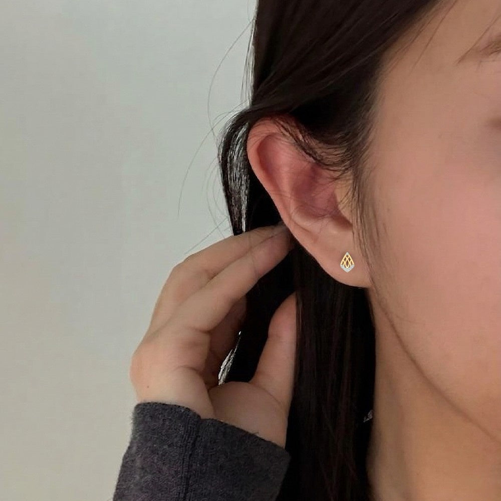 Close-up shot gold and diamond Geometric stud earring.
