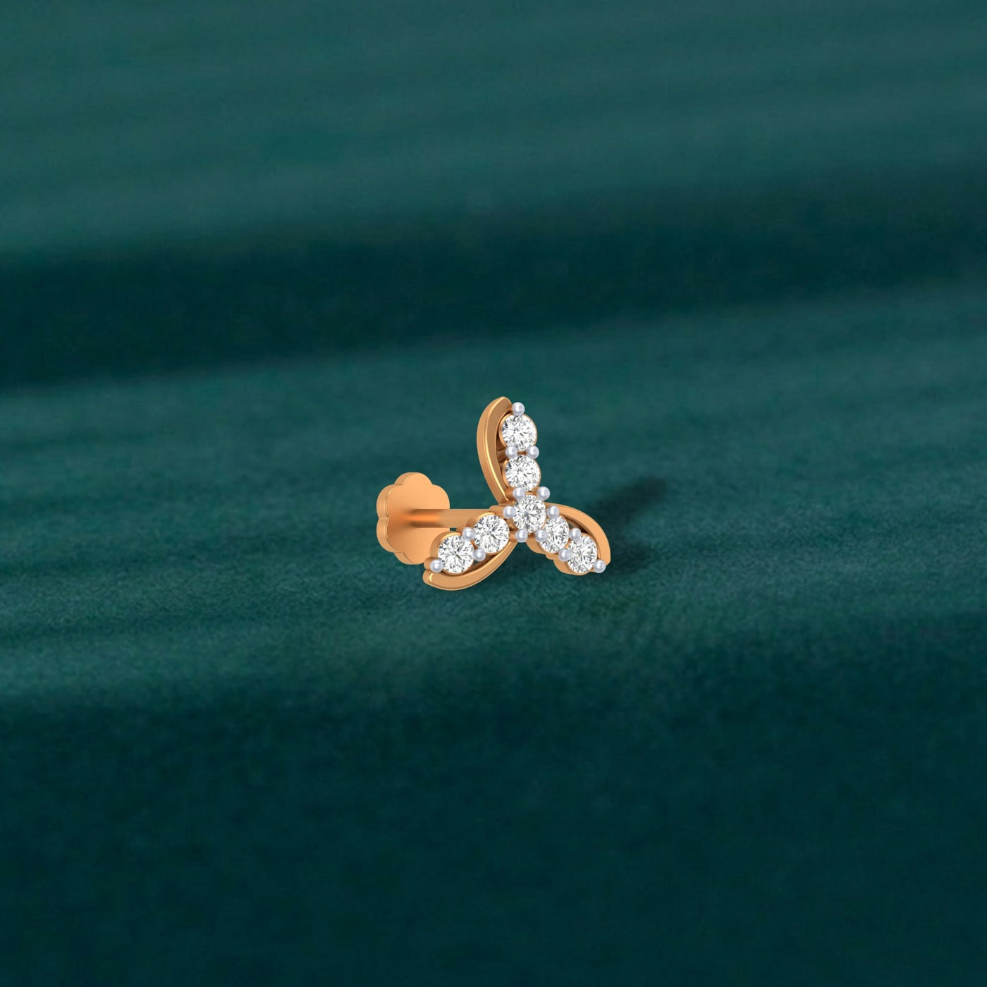 Yellow Gold and diamond stud nosepin diamonds on a teal background