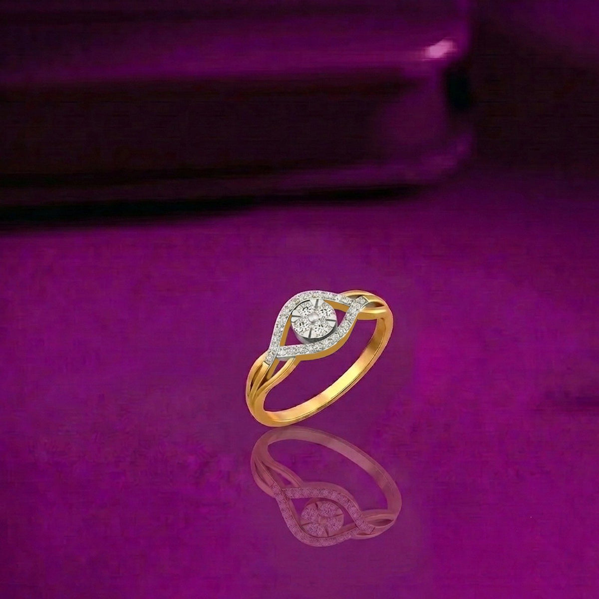 Gold and diamond cluster ring on a reflective surface.