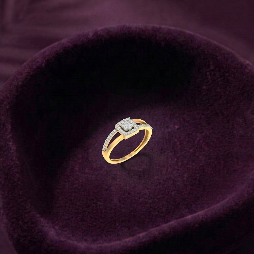 A gold ring with a square-cut diamond and pavé-set accents, displayed inside a deep purple velvet ring box.