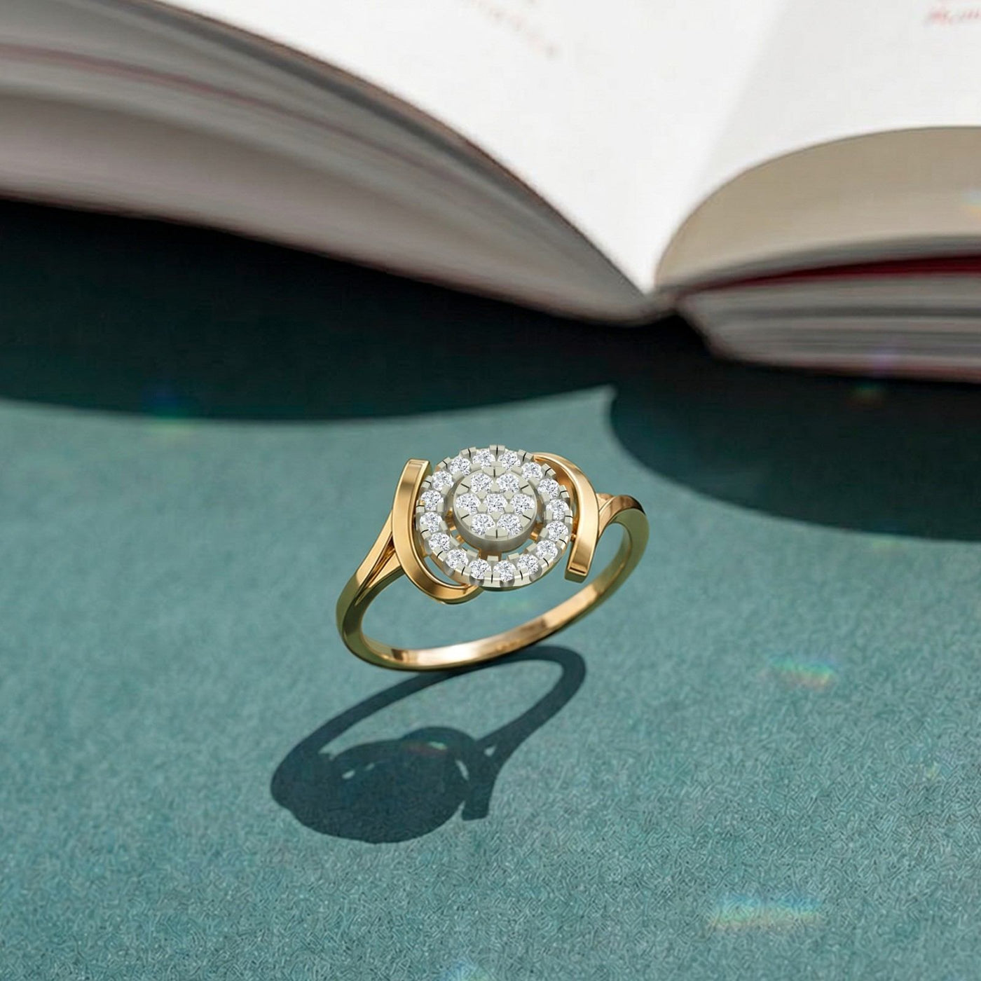 Gold and diamond with halo cluster setting on a teal surface.