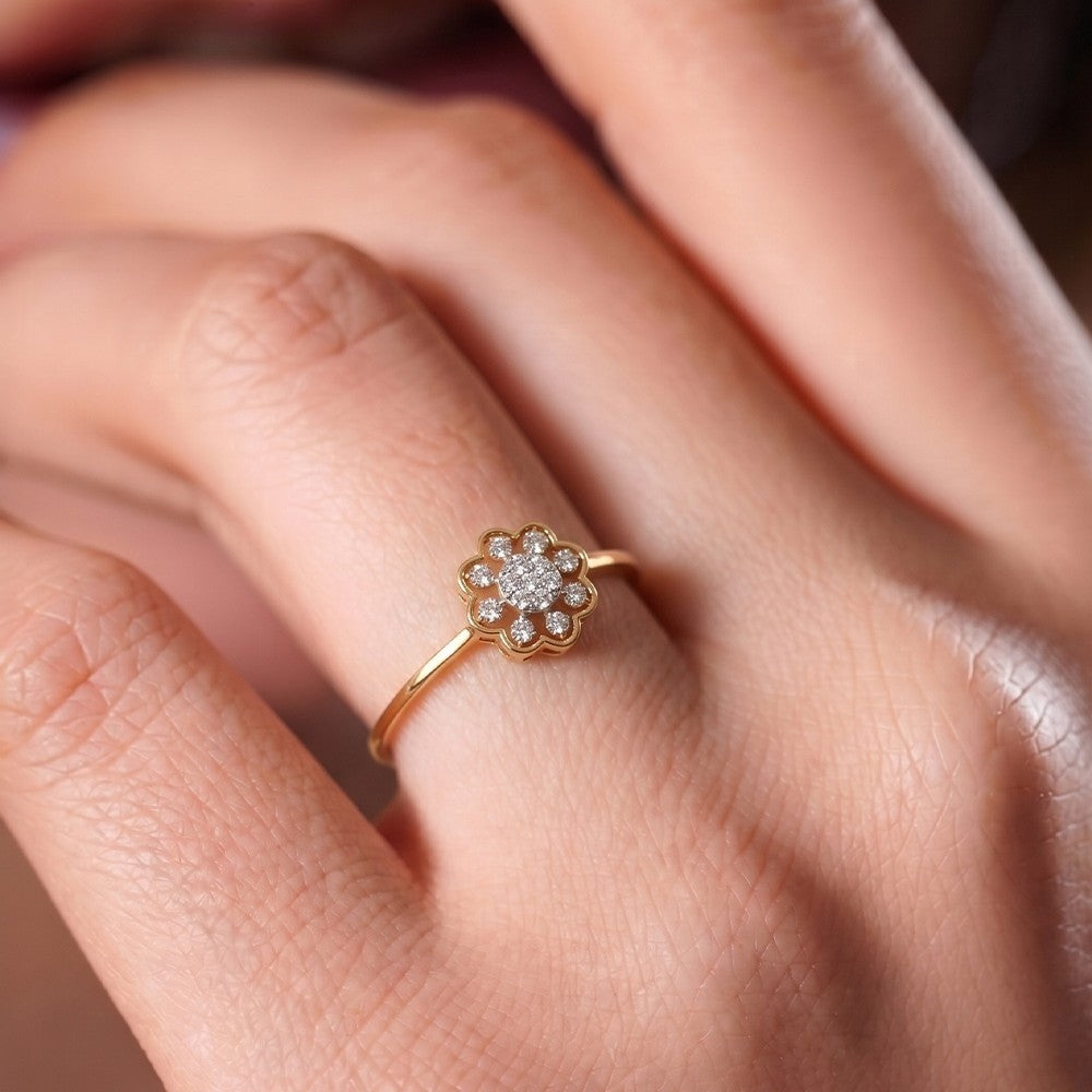Rose gold ring with a diamond floral design on a hand