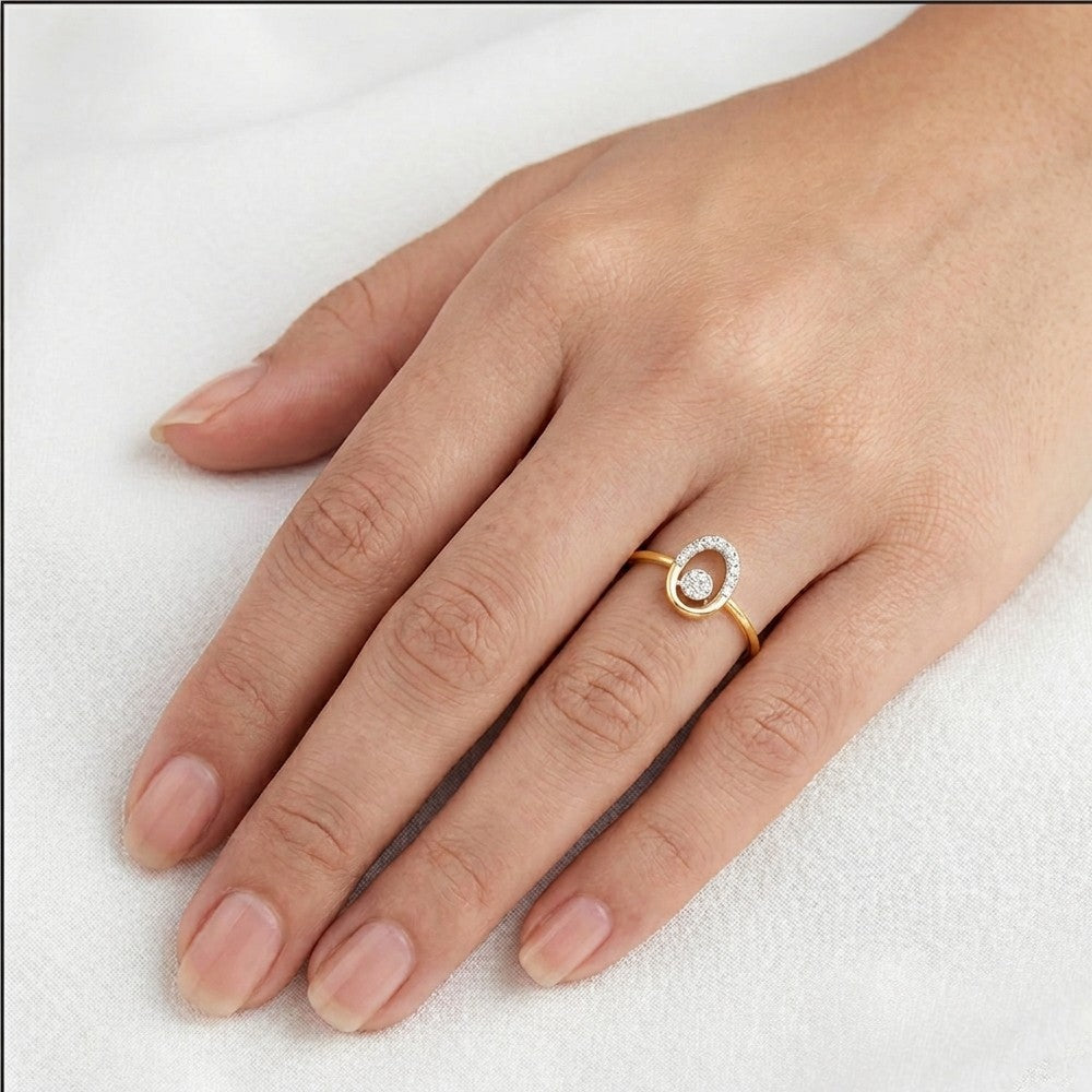Gold ring with a diamond on a hand against a white background