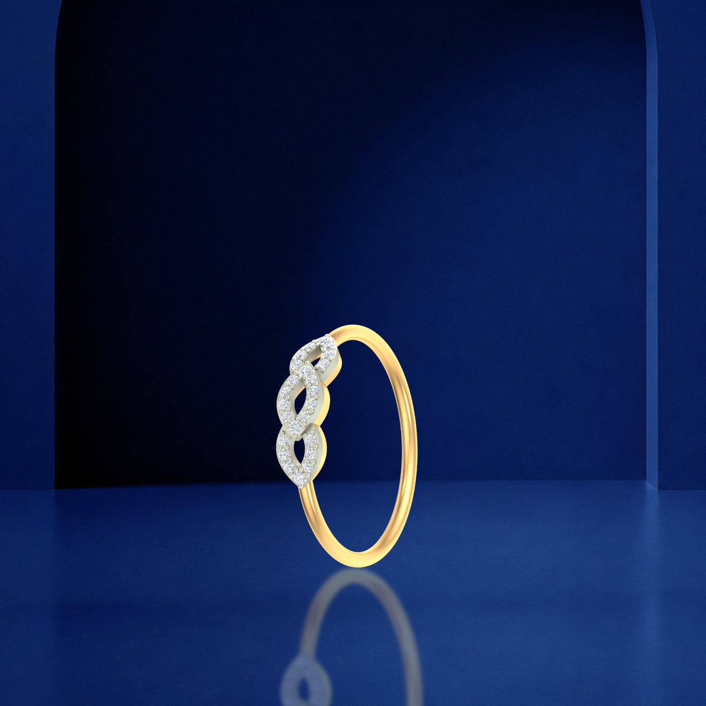 Gold and diamond women's ring on a blue reflective surface.