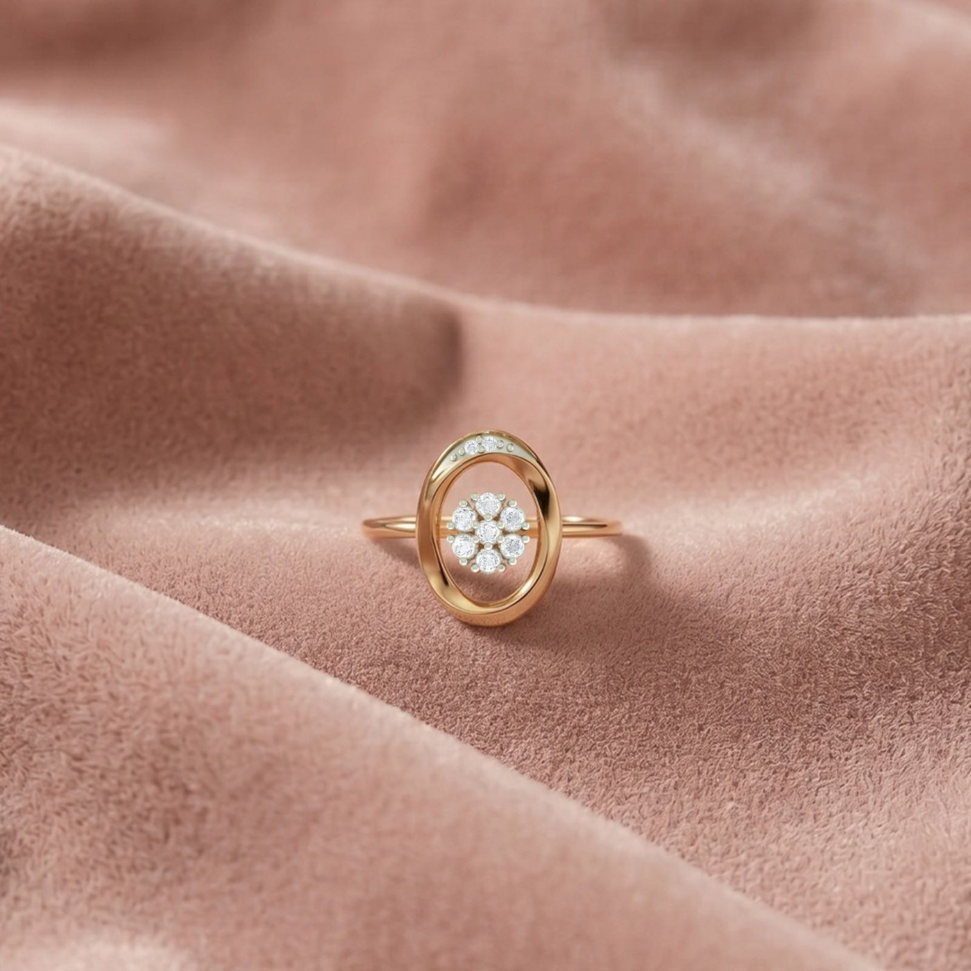 Gold and diamond with center floral cluster on a fabric surface.