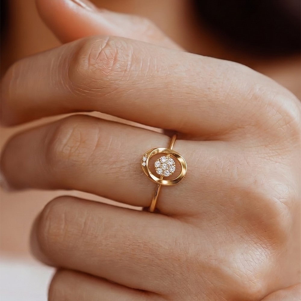 Gold ring with a diamond on a person's finger
