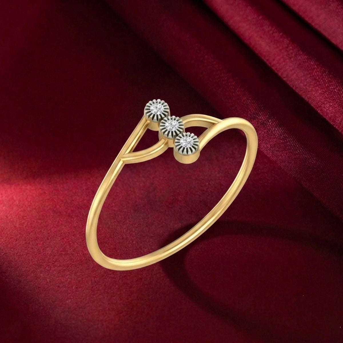 Gold and diamond ring on a red surface.