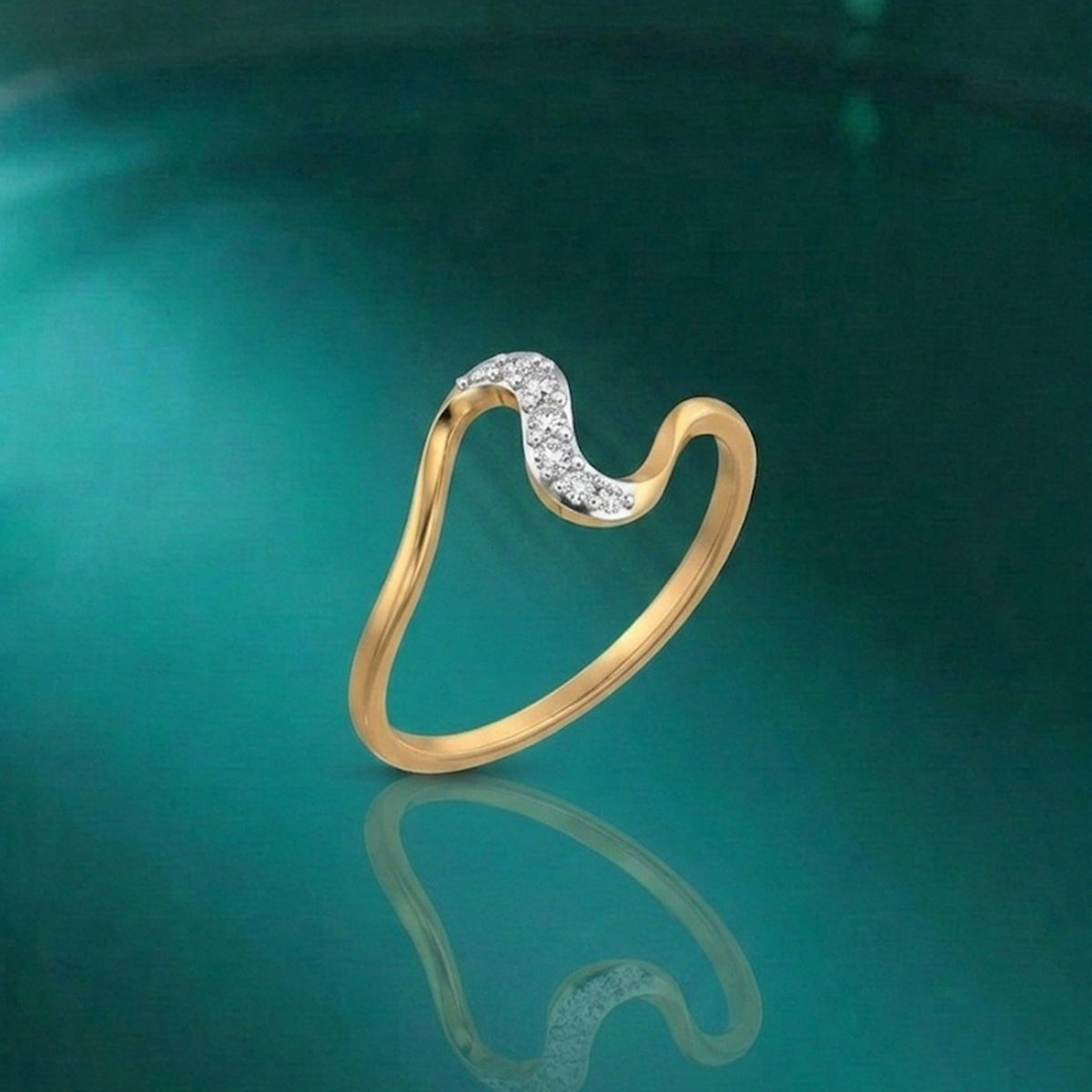 Gold and diamond half-eternity on a reflective blue surface.