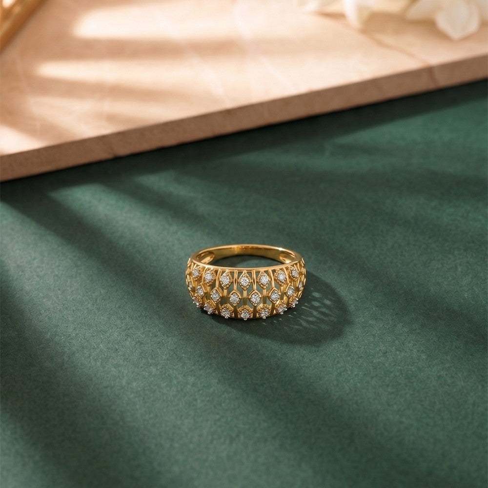 Gold aand diamond with mesh band ring on a green surface.