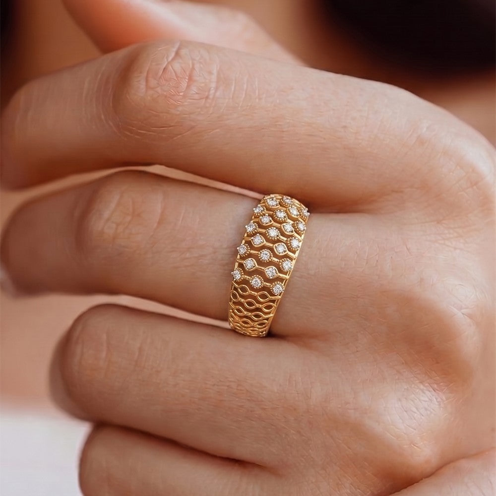 Close-up shot of a gold aand diamond with mesh band ring.