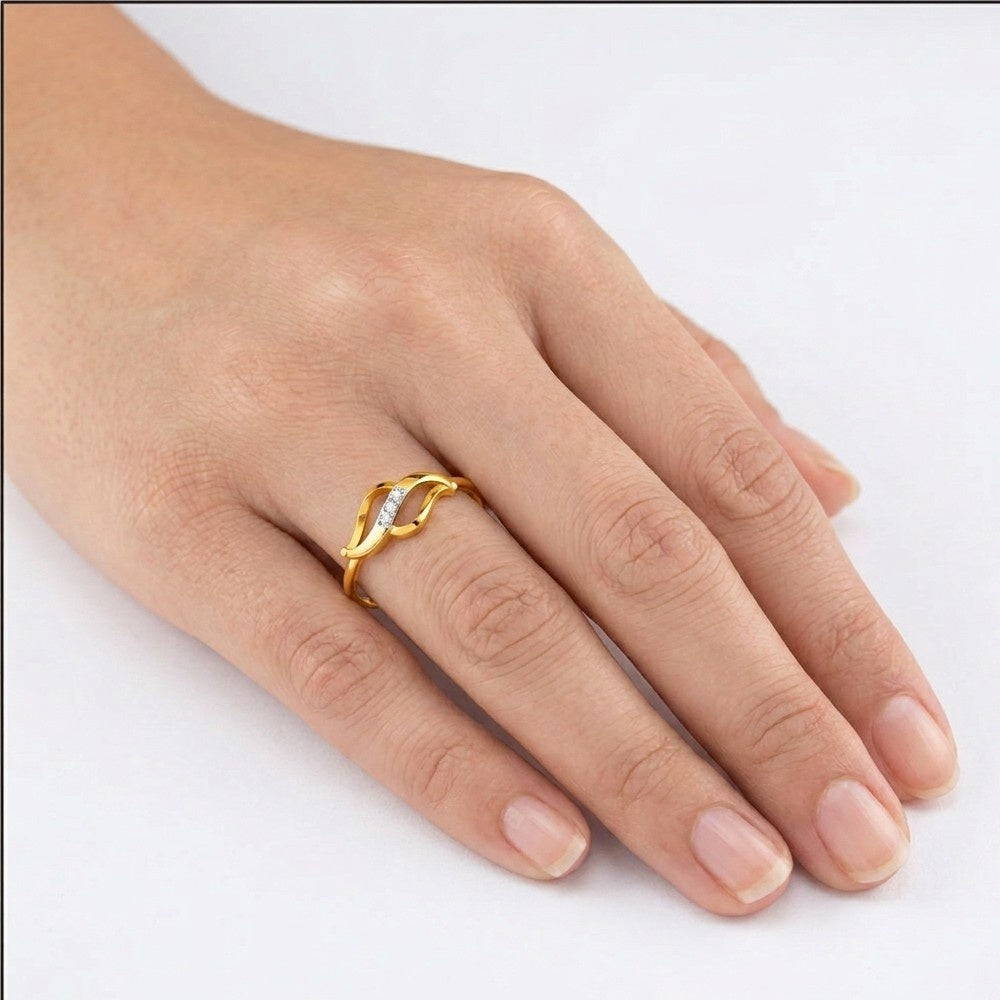 Gold ring with a diamond on a hand against a white background
