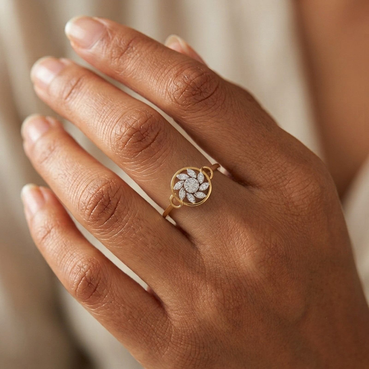Gold and diamond with cluster setting on a person's finger.
