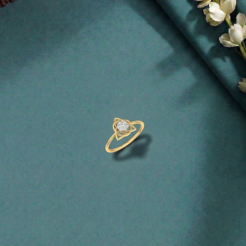 Gold and diamond with cluster setting on a teal surface.