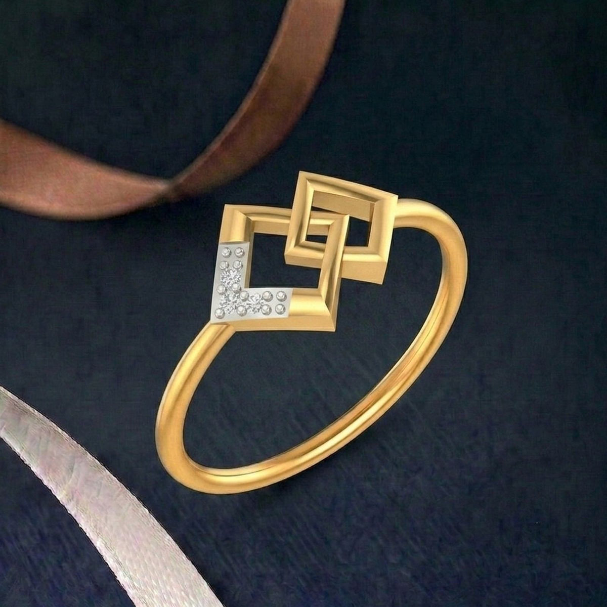Gold ring with geometric design on a teal surface.