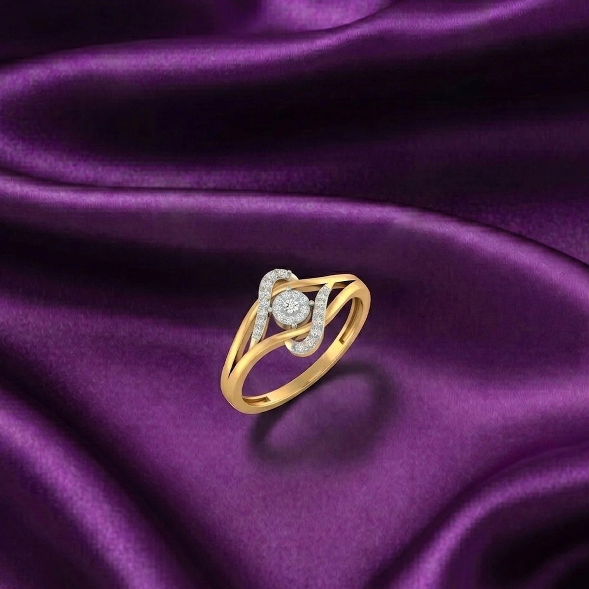 Gold ring with a central round diamond, shown on a purple fabric background.