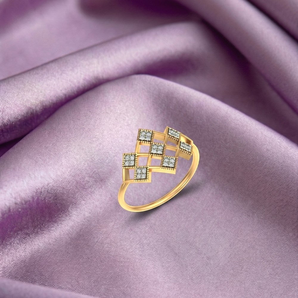 Gold ring with gemstones on a purple fabric background