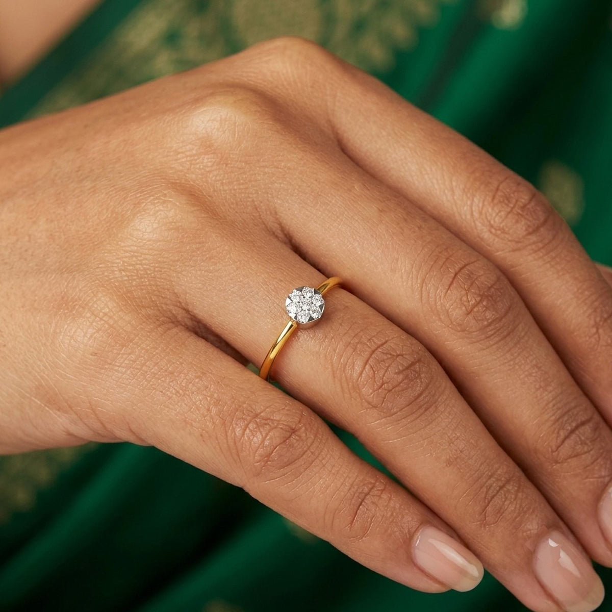 Close-up shot of a gold and diamond with cluster setting ring.