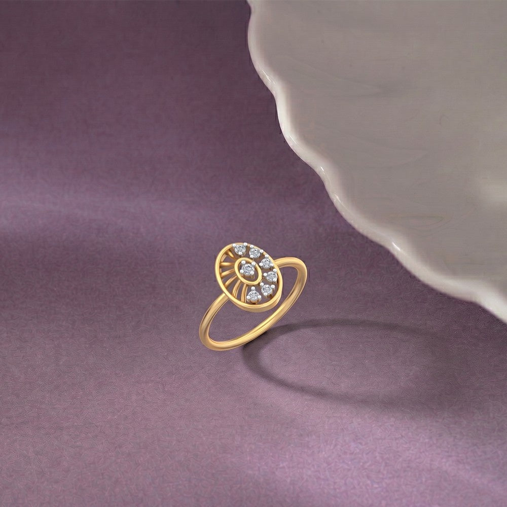 A yellow gold ring featuring an oval sunburst design accented with small diamonds