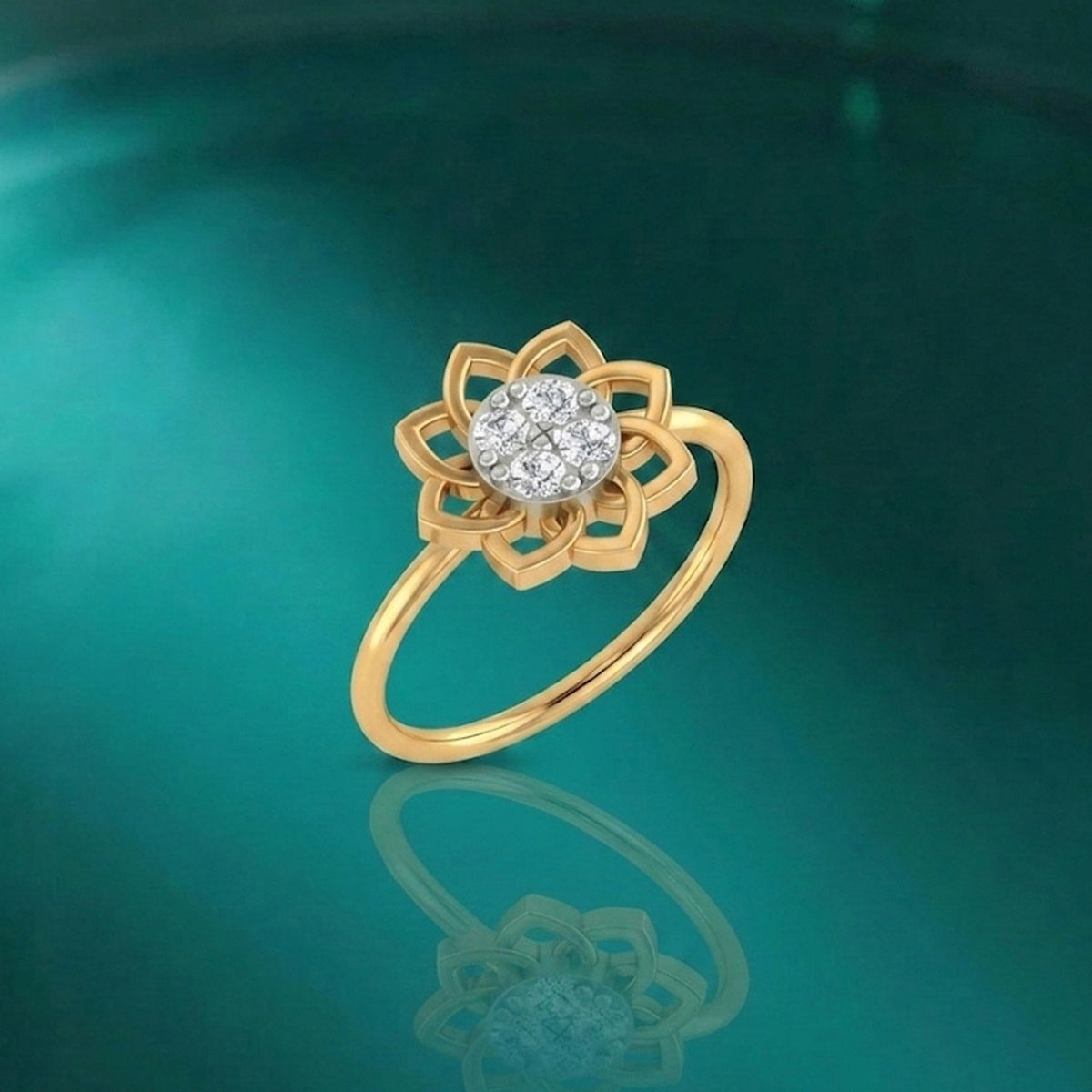 Gold ring with a diamond on a reflective green surface.