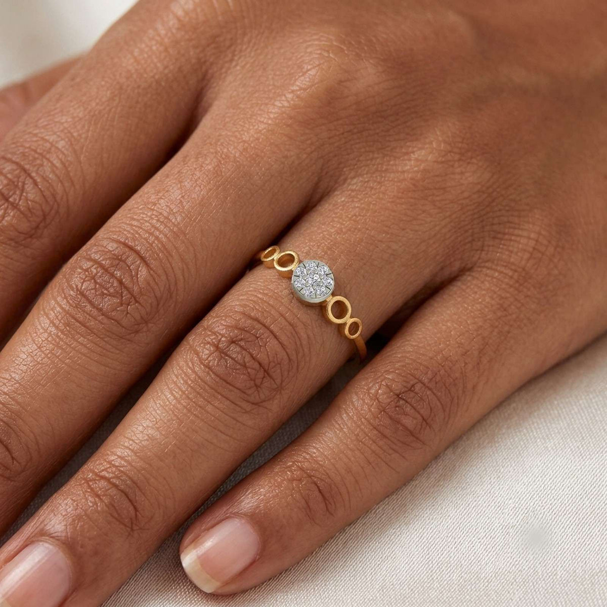 Close-up shot of a gold and diamond with cluster setting ring.
