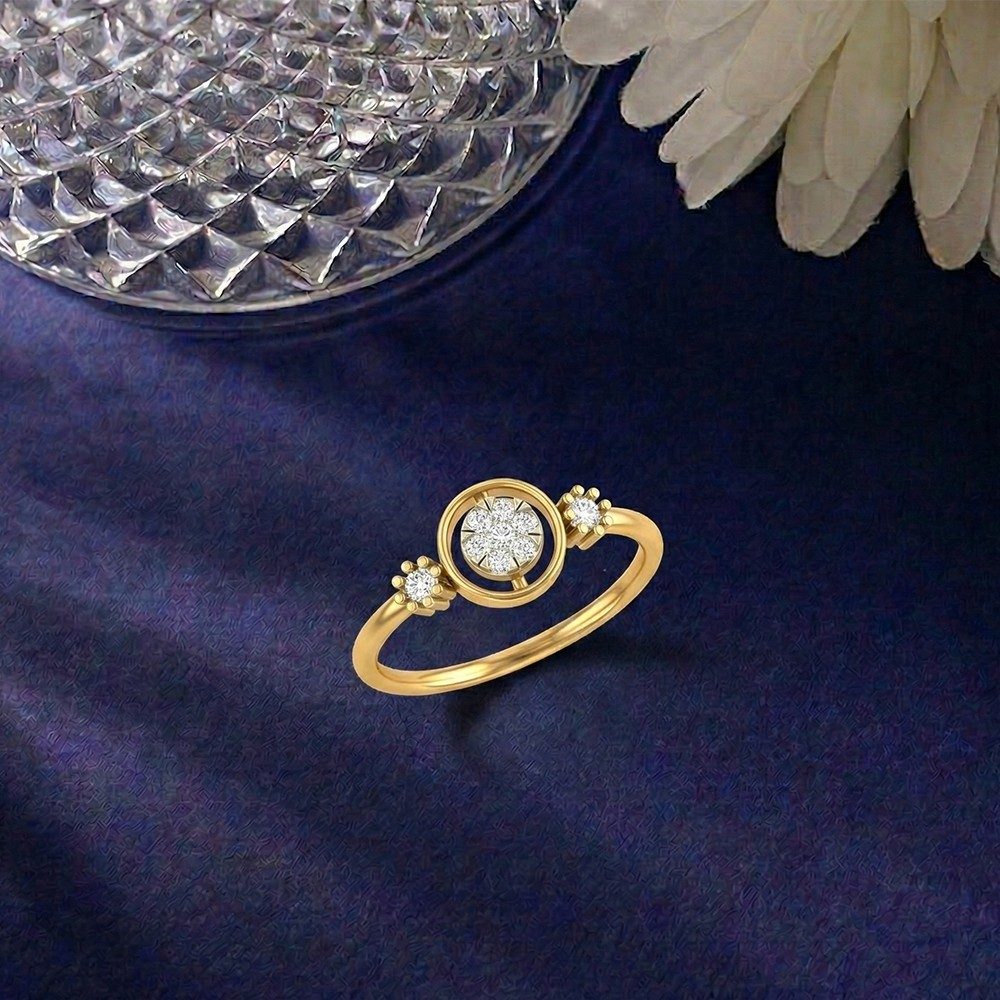 Gold ring with a diamond on a dark blue fabric background