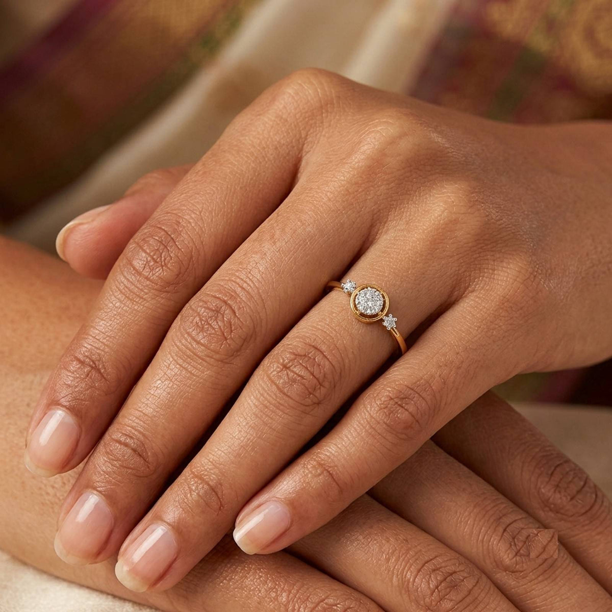 Gold ring with a diamond on a person's finger.