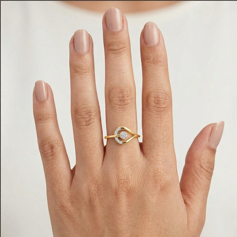 Gold ring with a diamond on a hand against a plain background