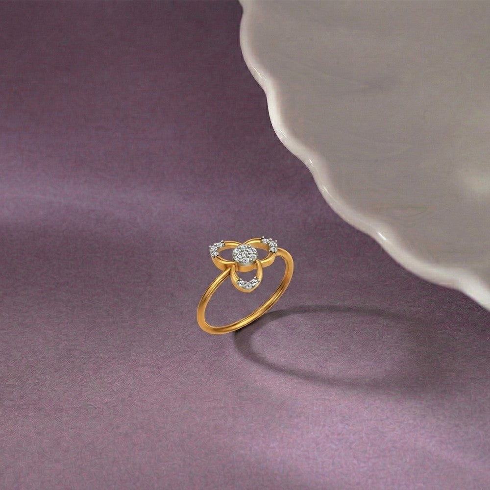 Gold ring with diamonds on a purple surface