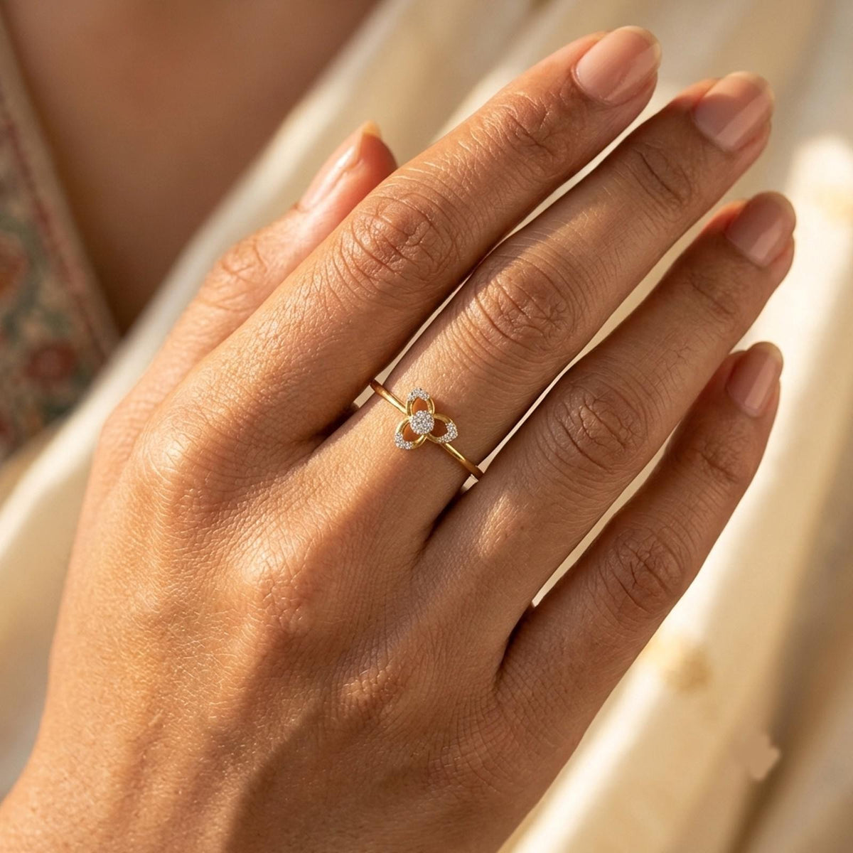 Gold ring with diamonds on a person's finger.