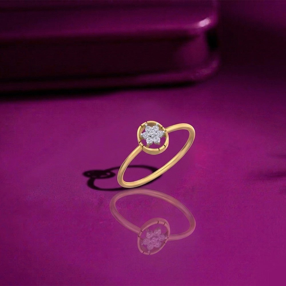 Gold ring with a diamond on a purple surface