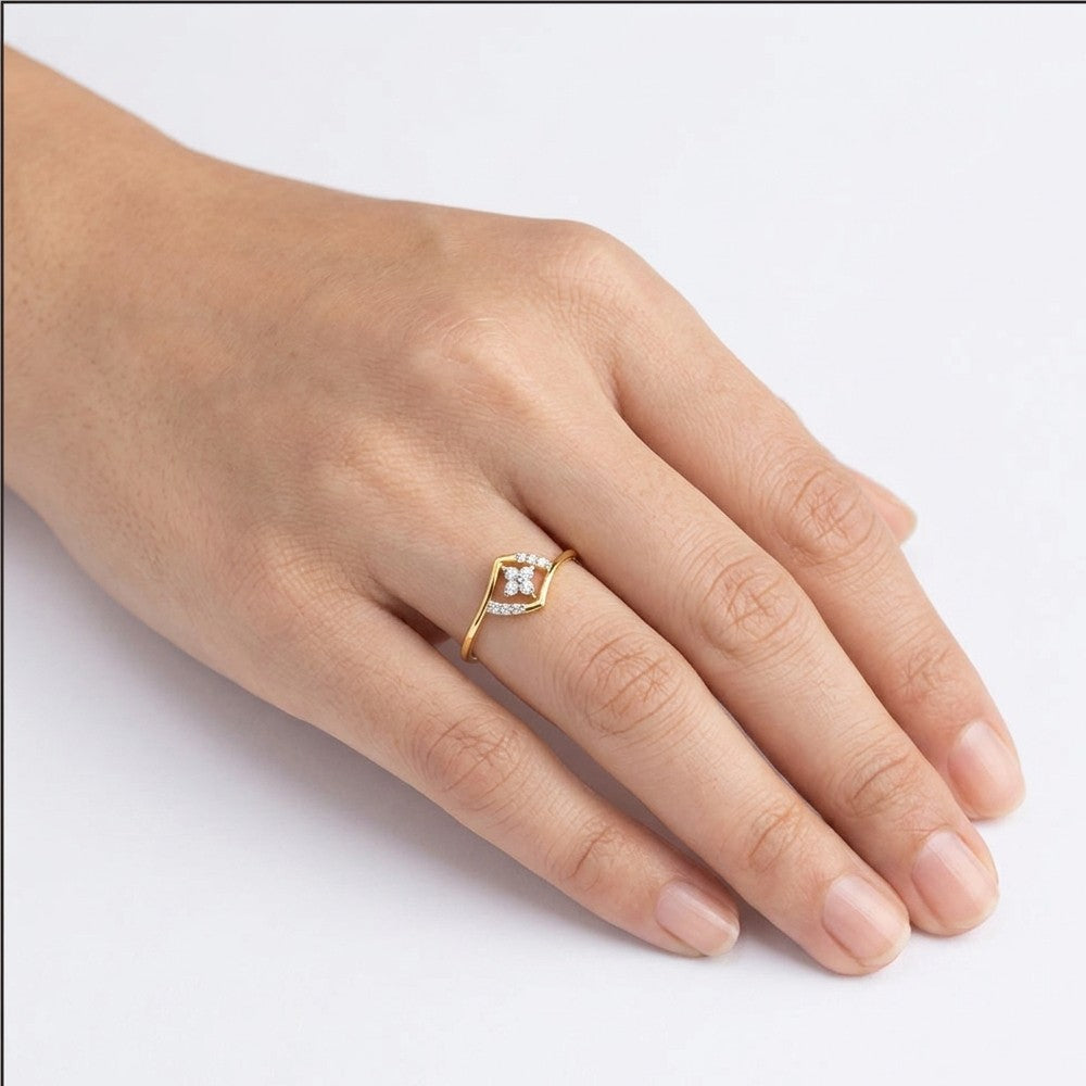 Gold and diamond with floral-design cluster setting on a person's finger.