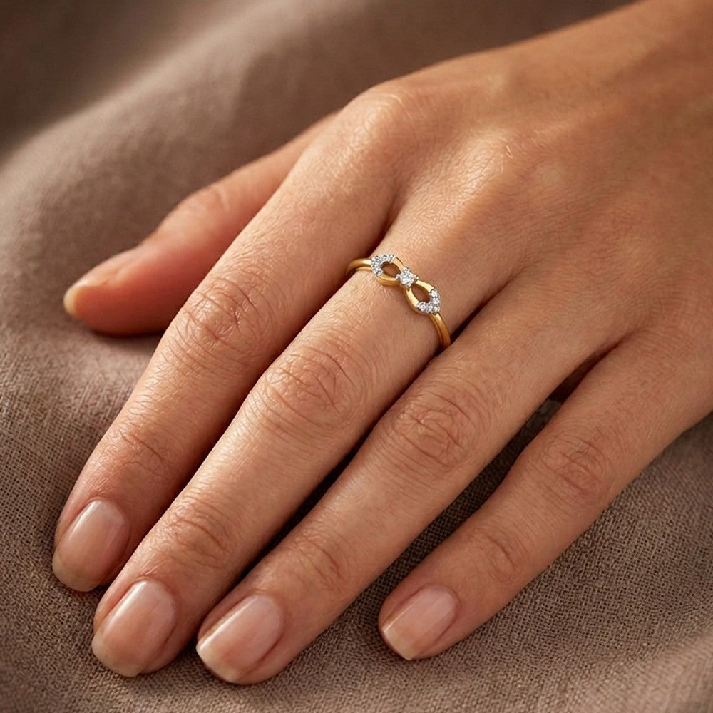 Gold and diamond with ring on a person's finger.