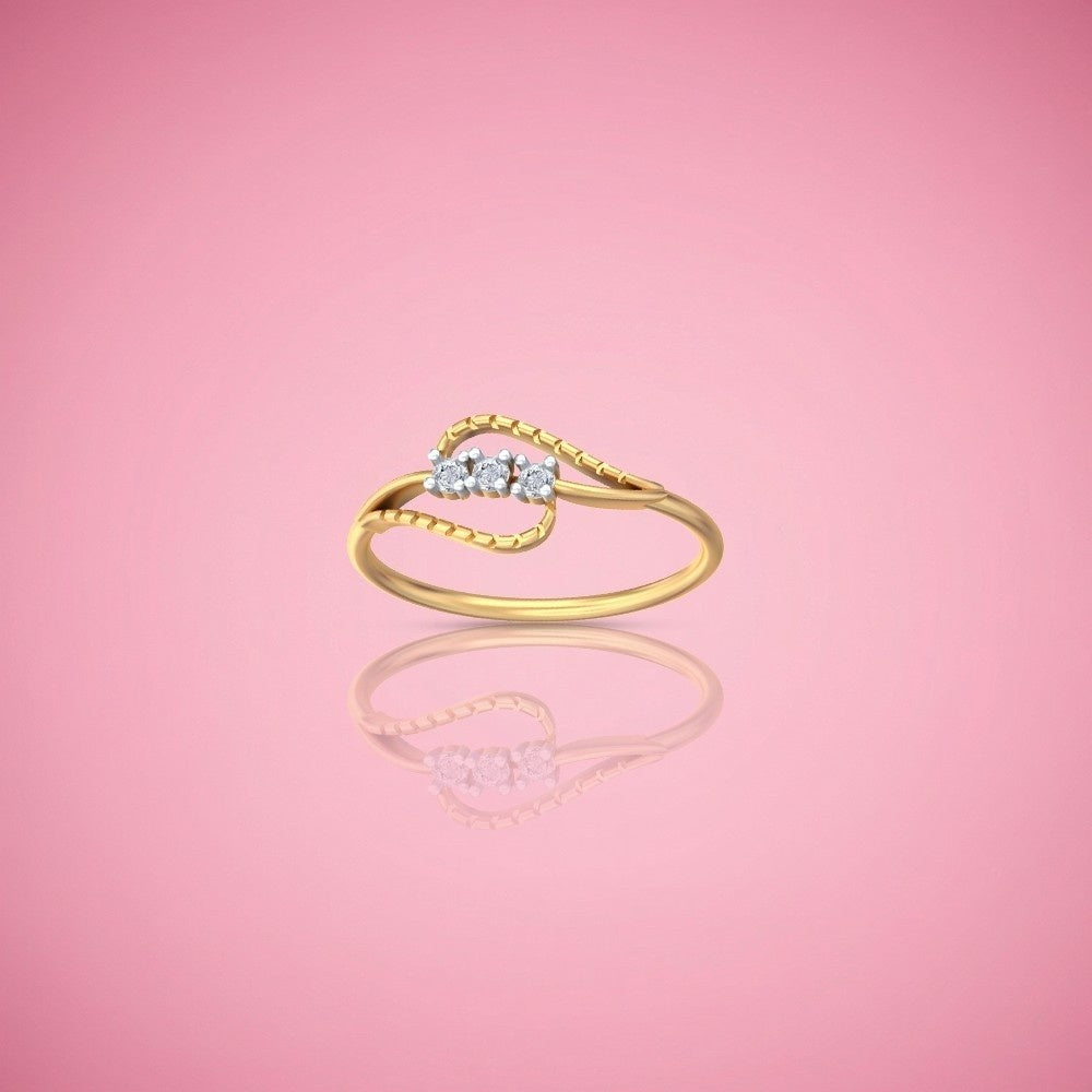 Gold ring with three small diamonds on a pink background