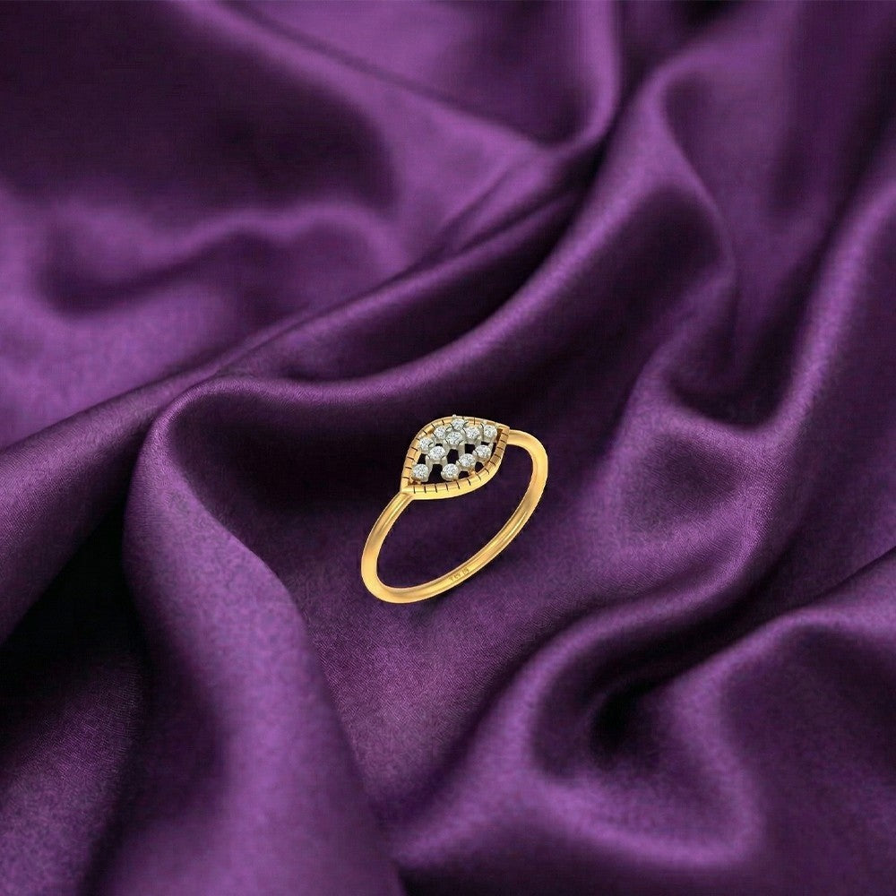 Gold rand diamond ing with cluster design on purple fabric.