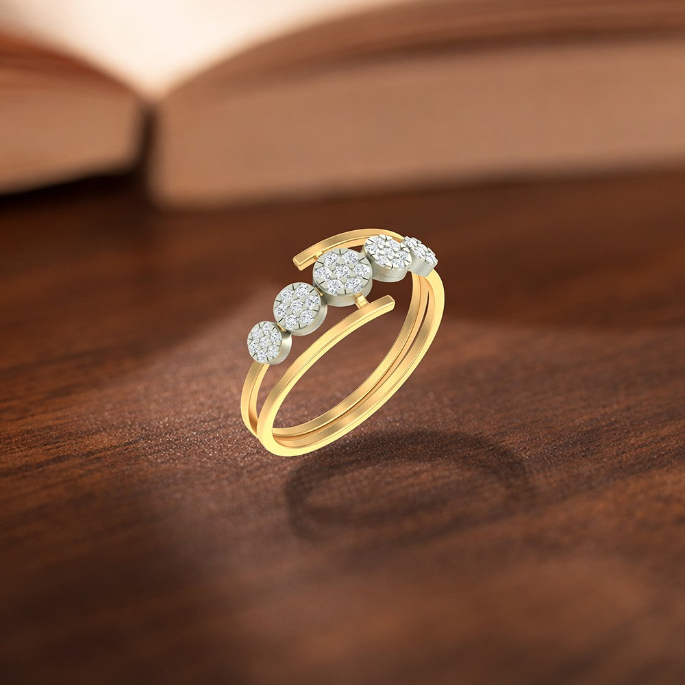 Gold and diamond with five round cluster setting on a wooden surface. 
