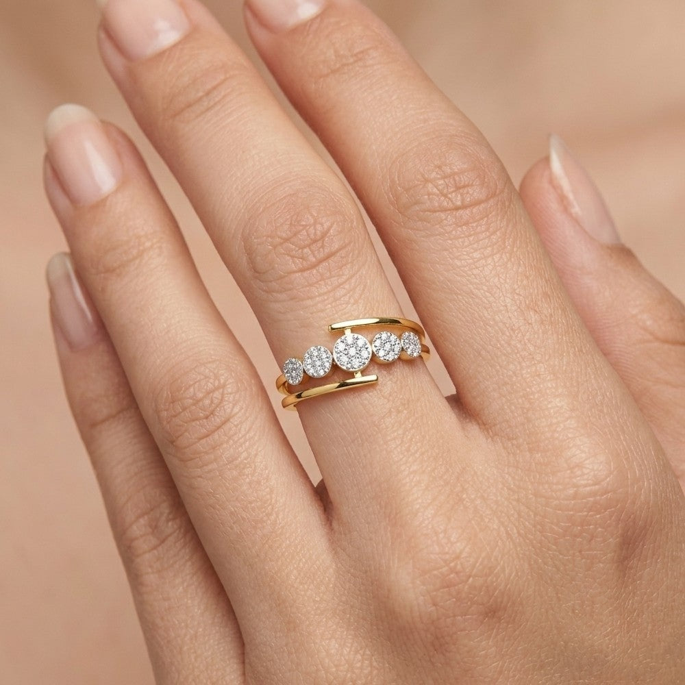 Close-up shot of a gold and diamond with five round cluster setting women's ring.