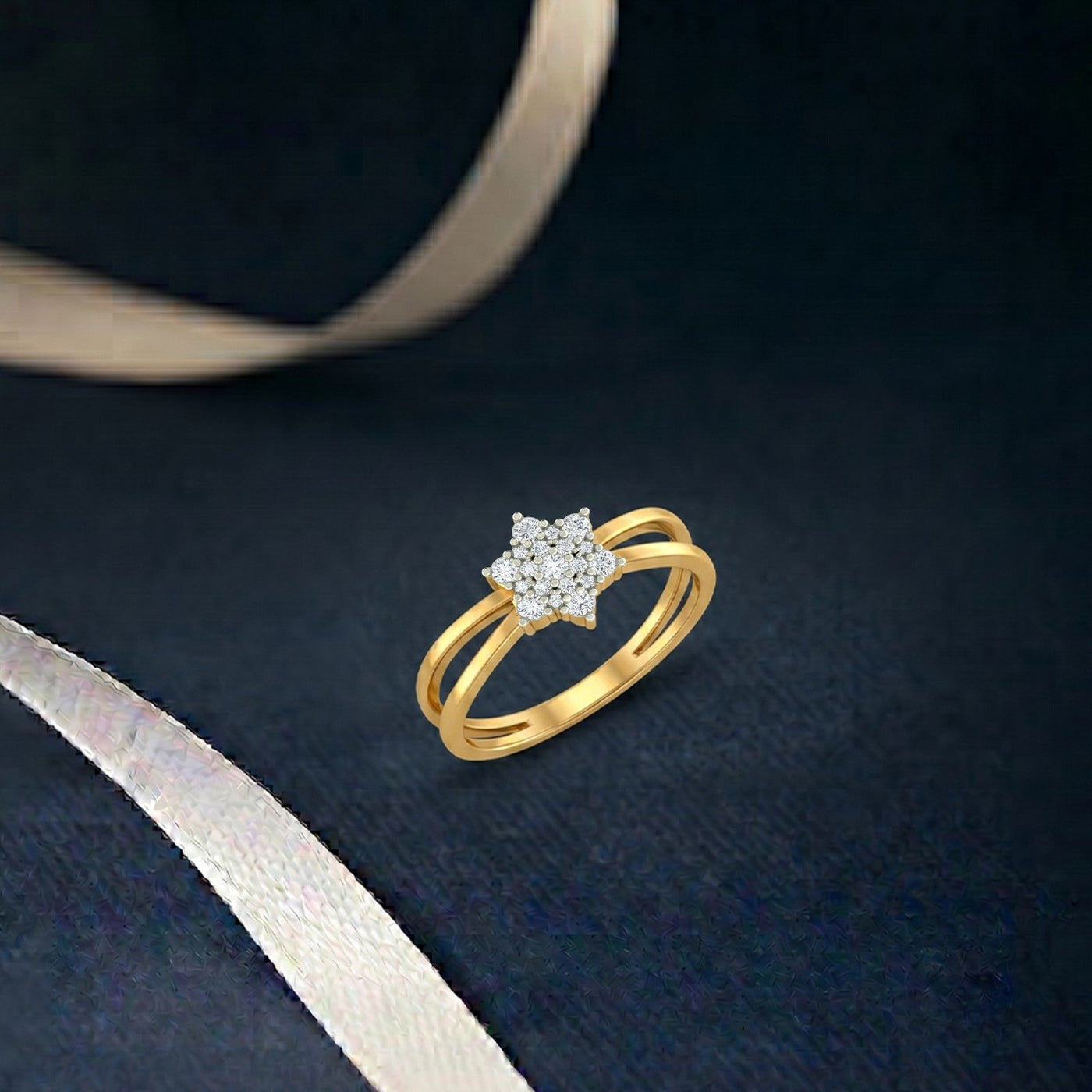 Gold and diamond with floral cluster on a navy blue surface.