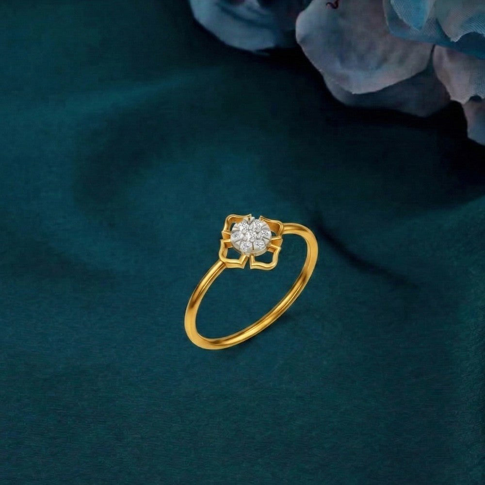 Gold and diamond with floral-design and cluster setting on a teal surface.