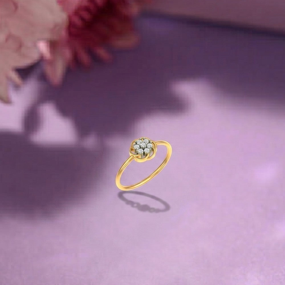 Gold ring and diamond with floral design on a purple surface