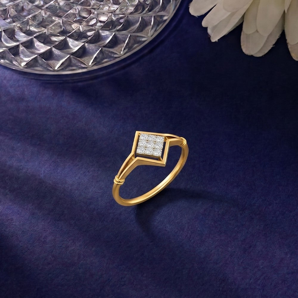 Gold and diamond with cluster setting on a blue surface.